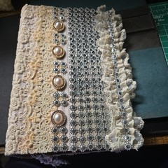 Junk Journal with fabric and beads has lace and sparkling front as pictured